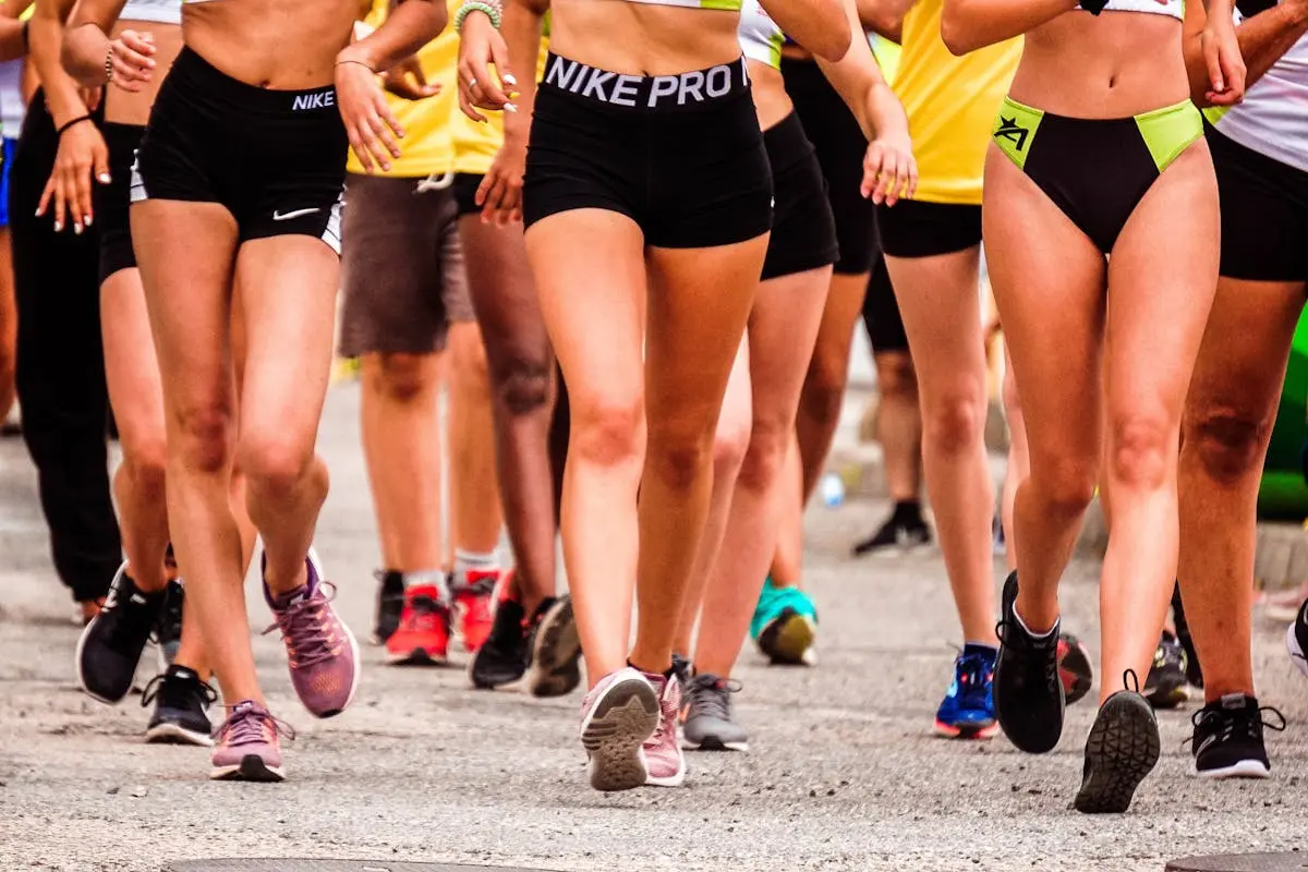 A group of runners participating in an outdoor street marathon wearing athletic gear.