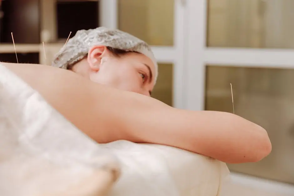 Close-up of a woman receiving acupuncture therapy in a serene setting.