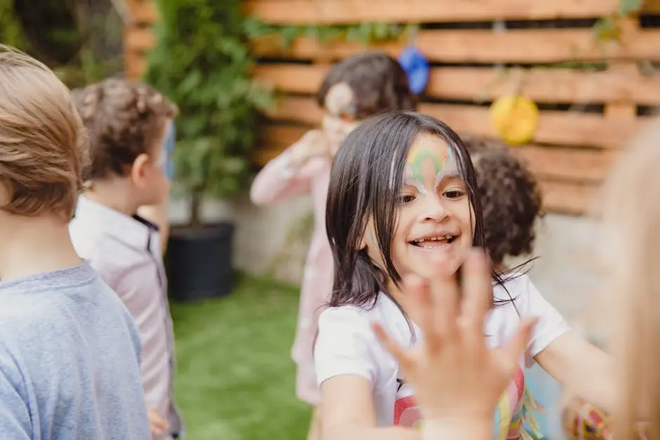 Children enjoy face painting at a sunny outdoor birthday party, filled with laughter and joy.