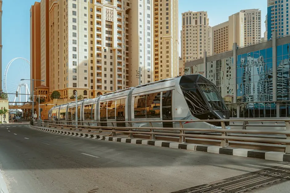 A sleek tram reflecting the urban skyline of Dubai, United Arab Emirates.