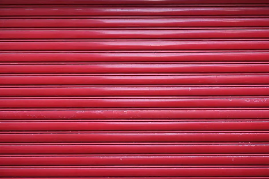 Close-up of red metal roll-up door showcasing a textured industrial design.