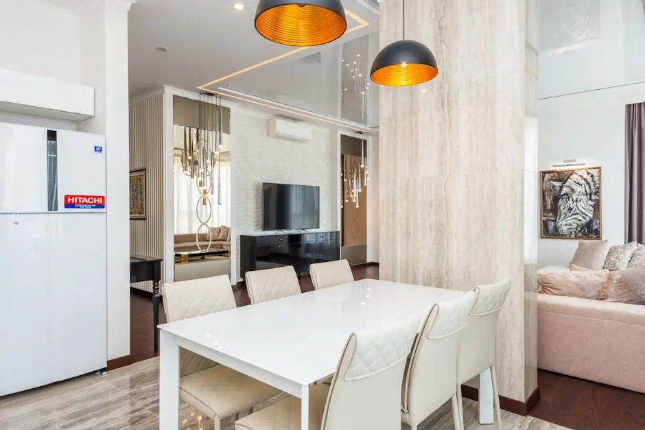 A contemporary dining room with elegant chairs and pendant lighting, creating a chic ambiance.