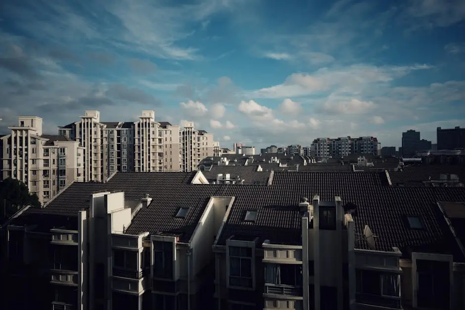 Cityscape of modern apartments with clear blue sky, showcasing urban living.