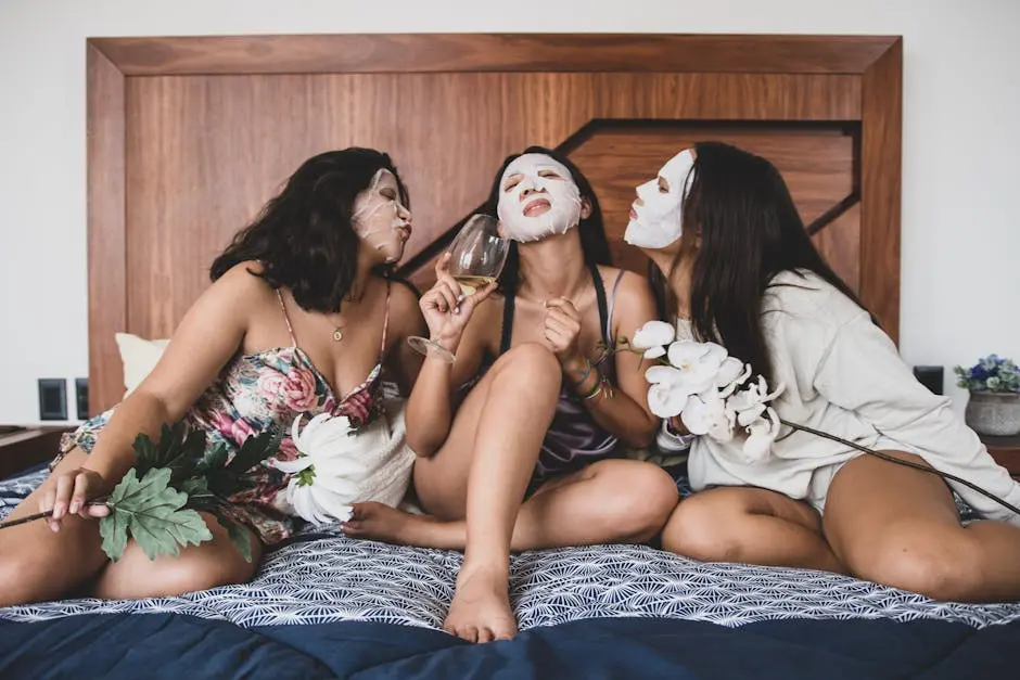 Three women bonding with sheet masks, flowers, and wine during a relaxing indoor pampering session.