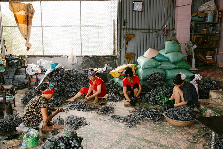Four women crafting items in a workshop, surrounded by materials and tools, showcasing manual labor and teamwork.
