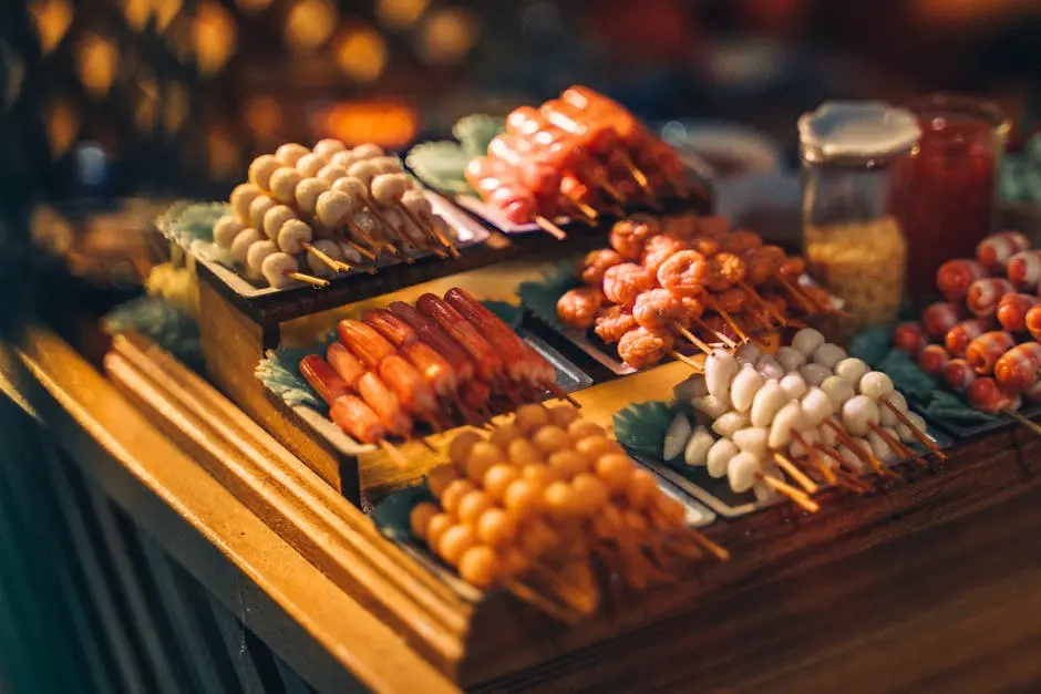 Colorful and mouth-watering assortment of Filipino street food skewers on a wooden table.
