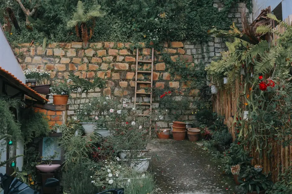Lush garden courtyard with stone wall and plants in Đà Lạt, Vietnam.
