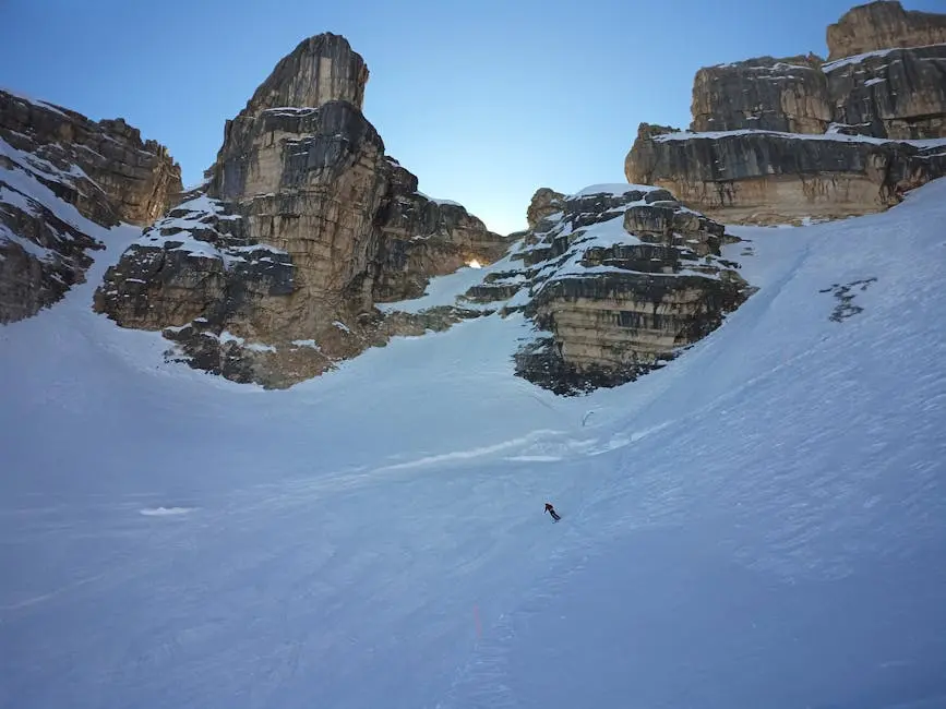 A skier descends snowy slopes in the dramatic Dolomite Mountains, Veneto, Italy.