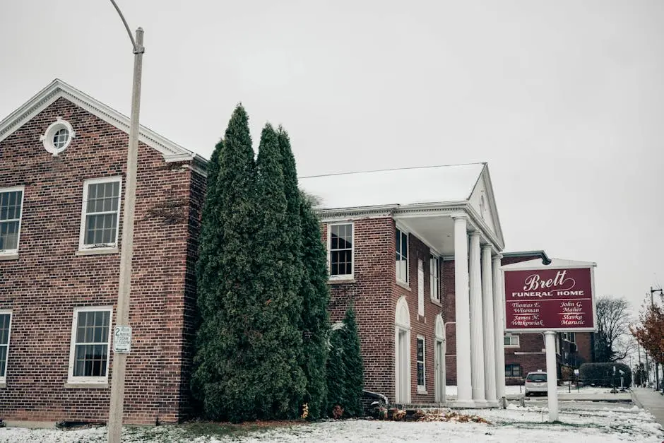 Snowy day view of Brett Funeral Home in Milwaukee, Wisconsin showcasing classic brick architecture.