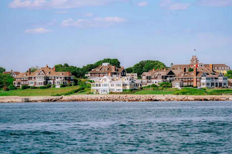 Scenic landscape of coastal luxury homes with lush greenery and tranquil waters.