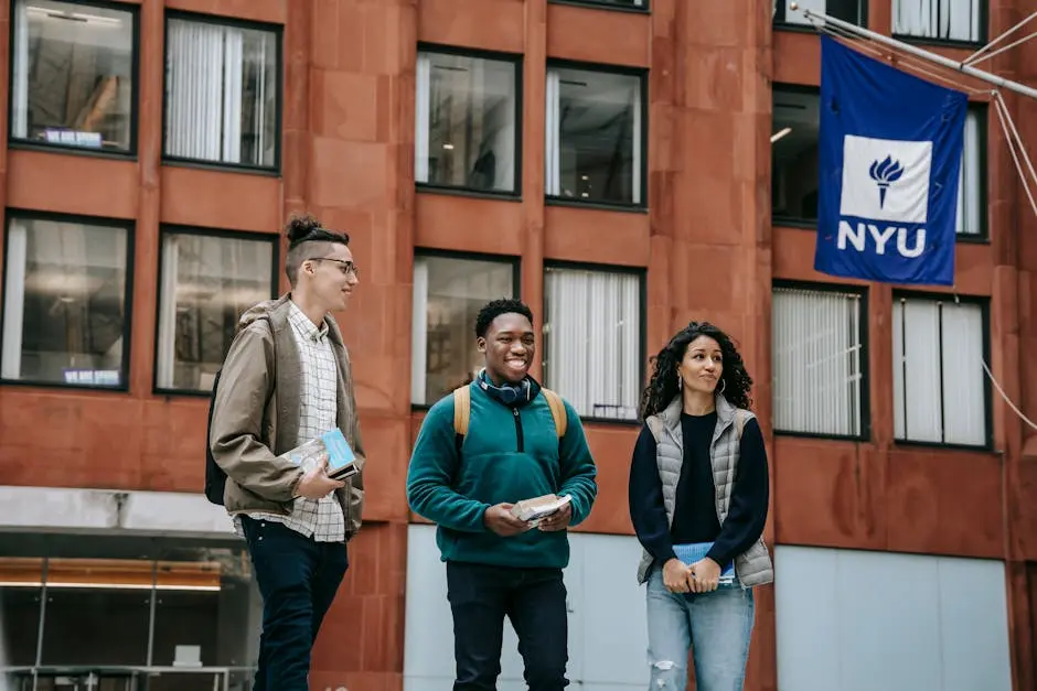 Group of happy multiracial friends with backpacks and notebooks smiling while standing near building and talking