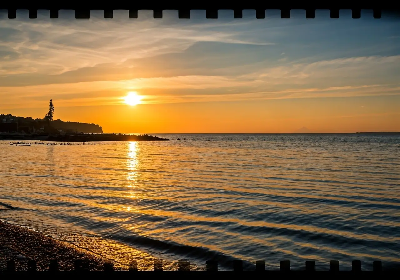 A serene sunset over a tranquil, quiet beach. 35mm stock photo