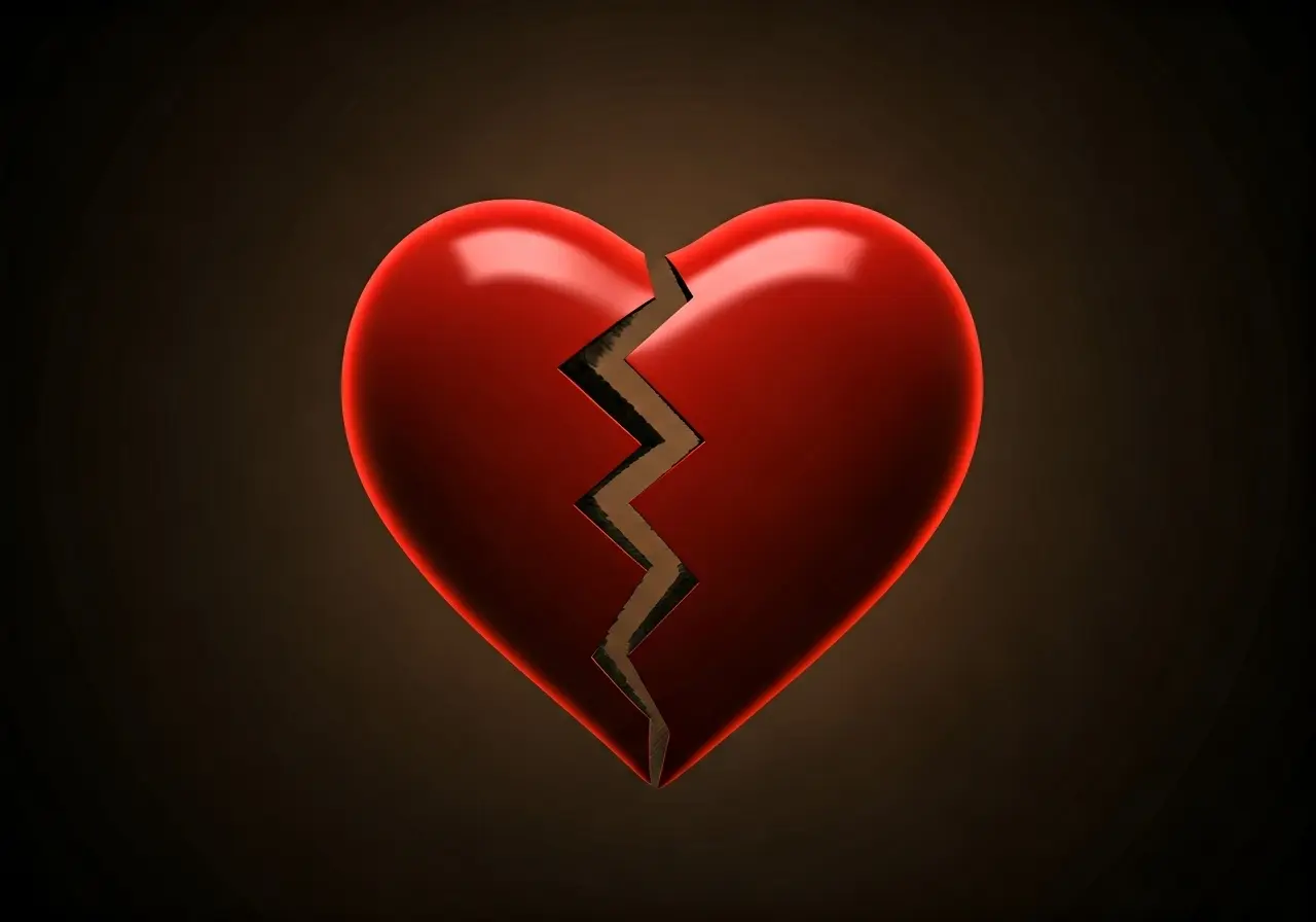 A heart split in two against a dark background. 35mm stock photo