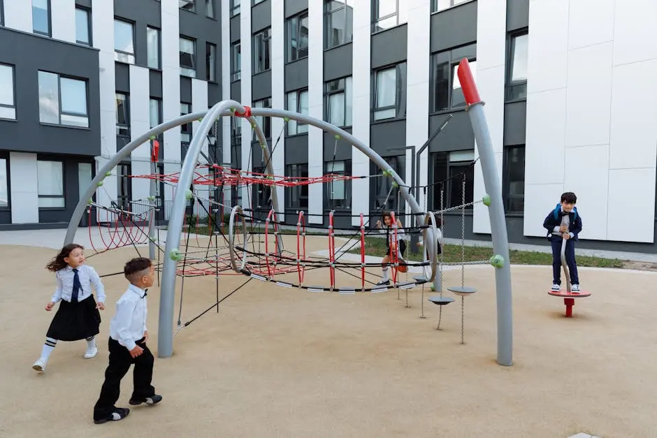 Children enjoy playtime in a modern school playground with climbing equipment.