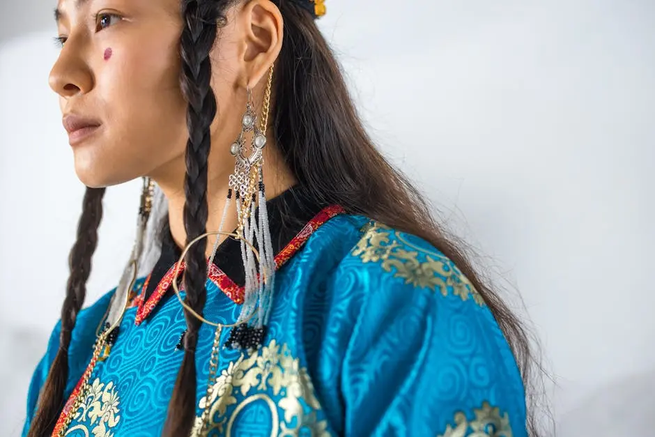 Close-up of a woman in traditional ethnic clothing with decorative earrings and braided hair.