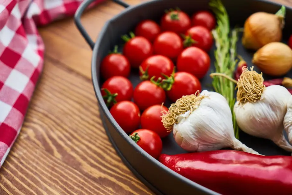 A vivid display of fresh Mediterranean vegetables on a wooden table with a pan.
