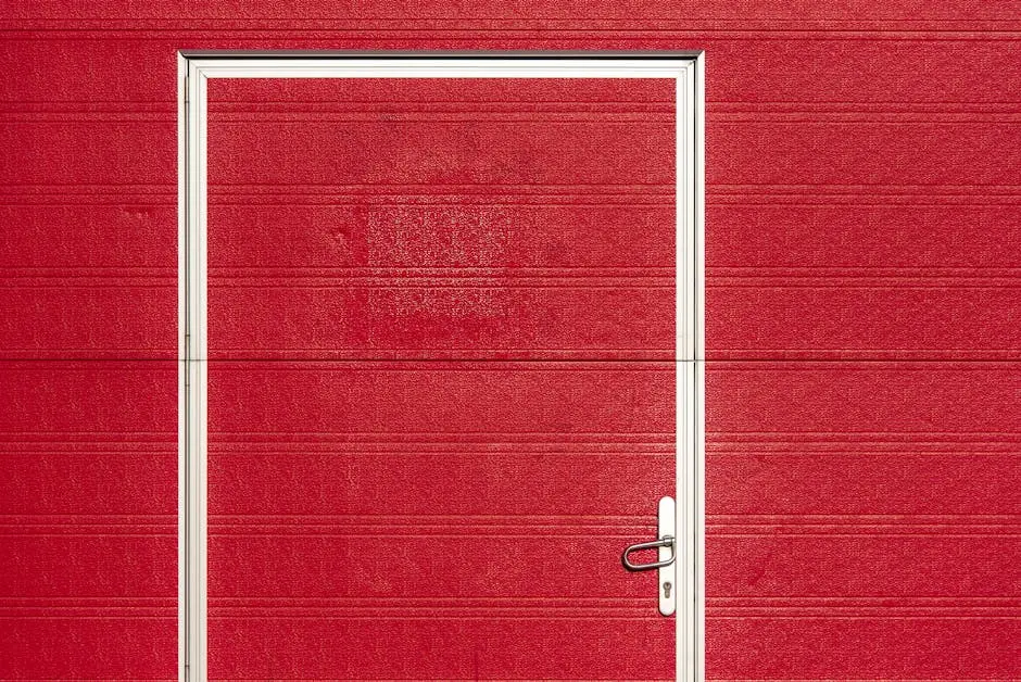 Minimalist image of a bold red garage door with a white frame and textured surface.