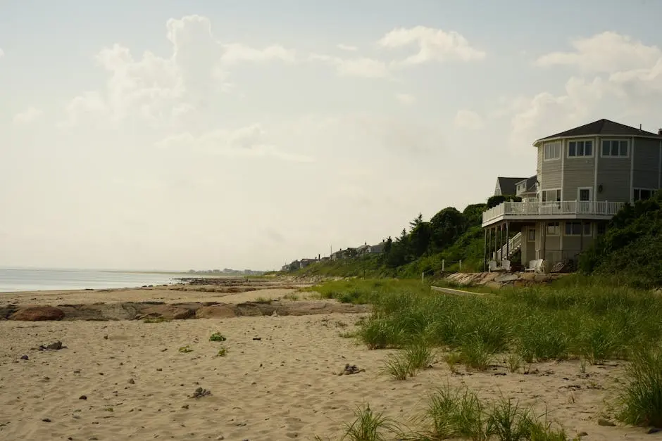 Tranquil sandy beach with coastal house, perfect for summer seaside retreats.