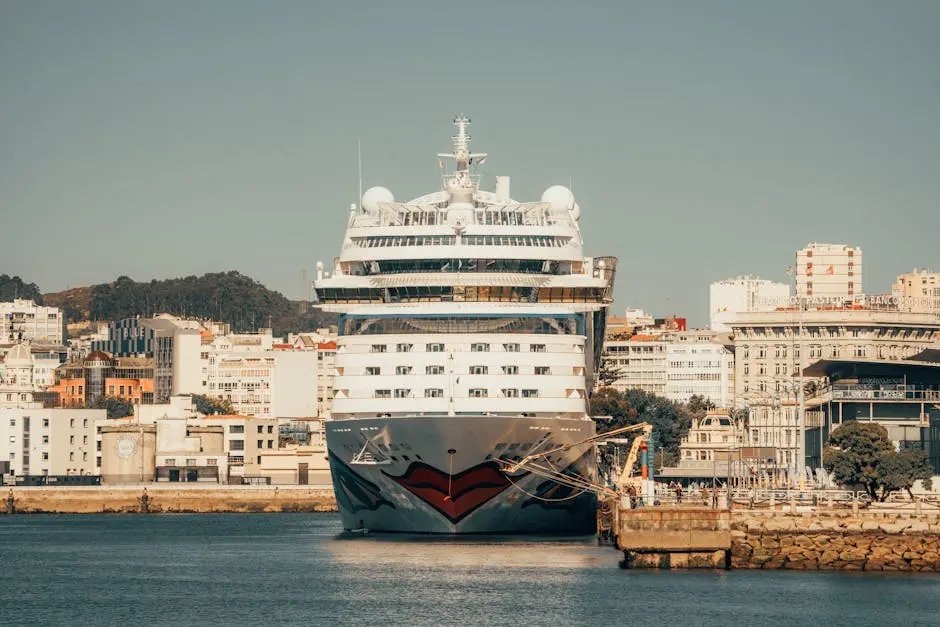 Massive cruise ship docked in a scenic urban harbor, with vibrant architecture and clear skies.