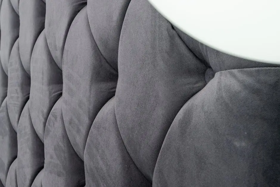 Detailed view of padded gray upholstery fabric showcasing texture and design.