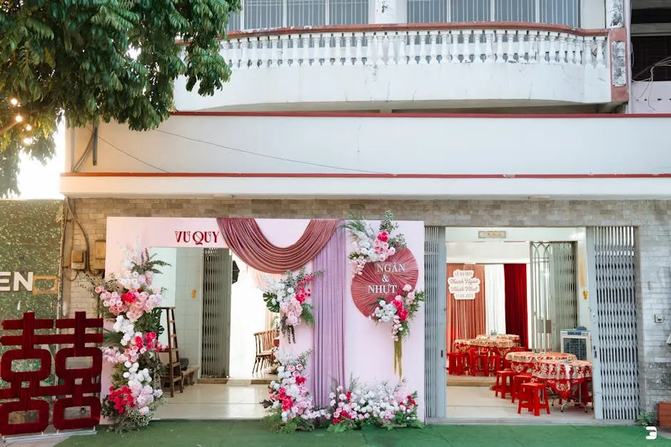 Charming outdoor wedding setting with beautiful floral décor in pink and red hues.