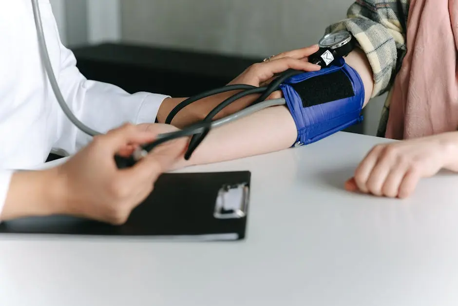 A healthcare worker uses a sphygmomanometer to check a patient&rsquo;s blood pressure in a medical office.
