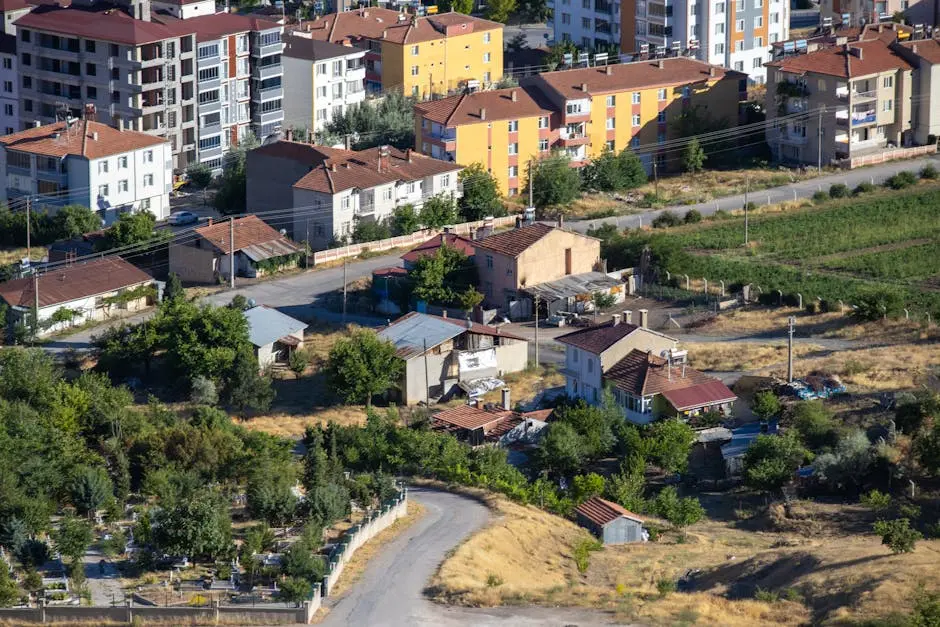A scenic aerial view of suburban Elazığ, showcasing residential buildings and greenery.