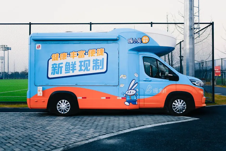 Brightly colored van with playful design and Chinese text parked on an urban street.
