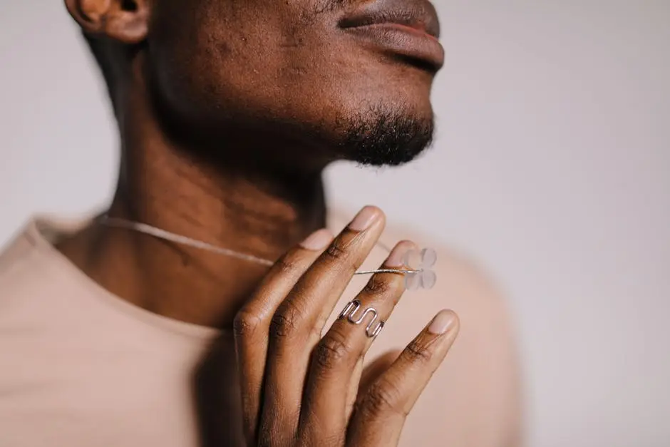 A close-up shot focusing on modern jewelry adorned by a hand, highlighting elegance and style.