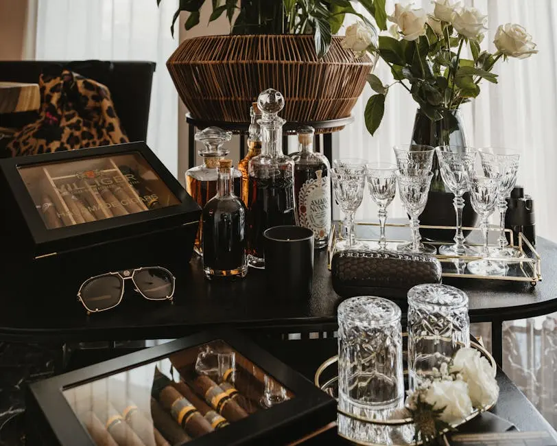 Luxurious still life of a bar table with crystal glassware, cigars, and alcohol bottles.