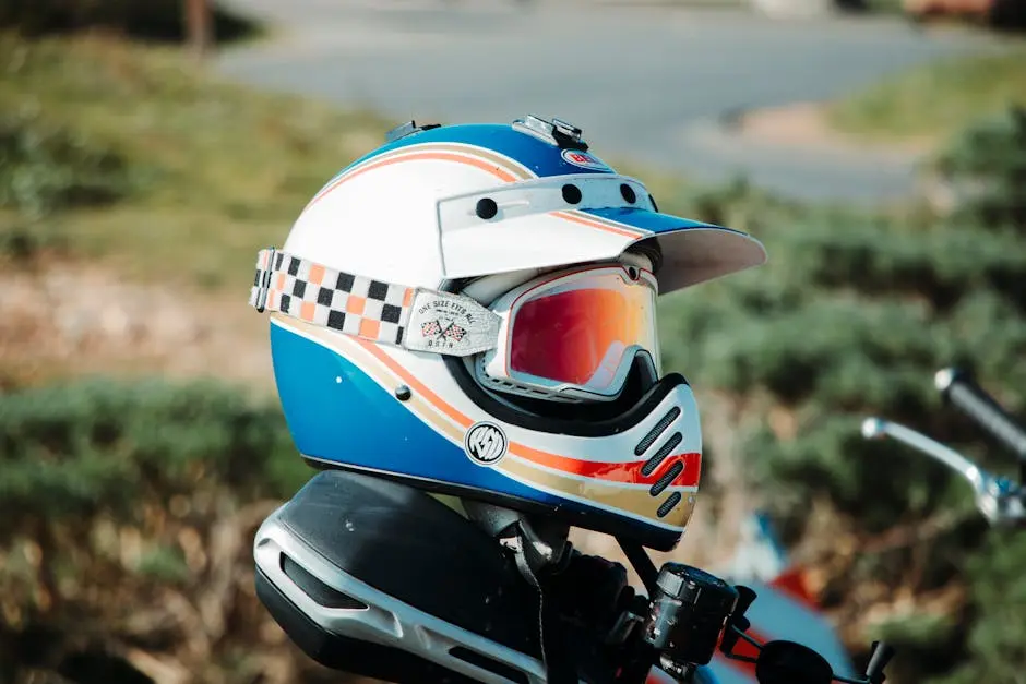A vibrant motorcycle helmet with visor gear, photographed outdoors showcasing safety equipment.
