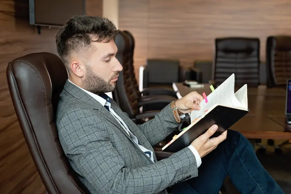 Professional businessman in formal attire reviewing notes in a modern office environment. Career Change