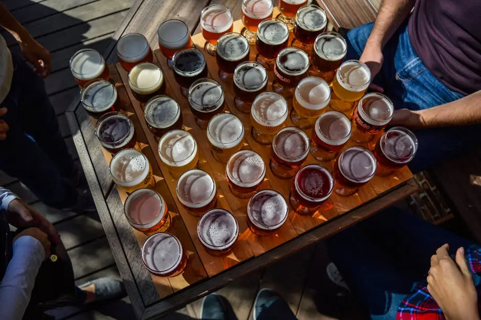 A group of friends enjoying various beers outdoors on a sunny day.