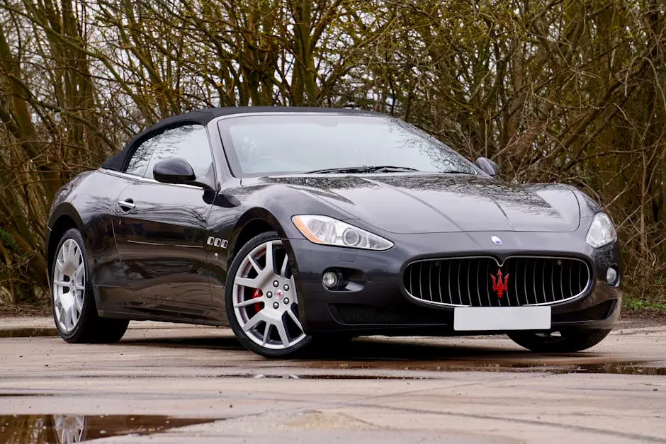 Sleek Maserati convertible parked outdoors, reflecting elegance and power.