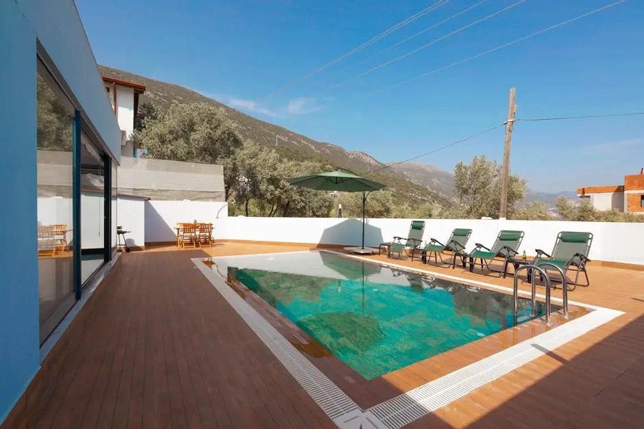 Relax at a luxurious villa with mountain-view pool and sun loungers.