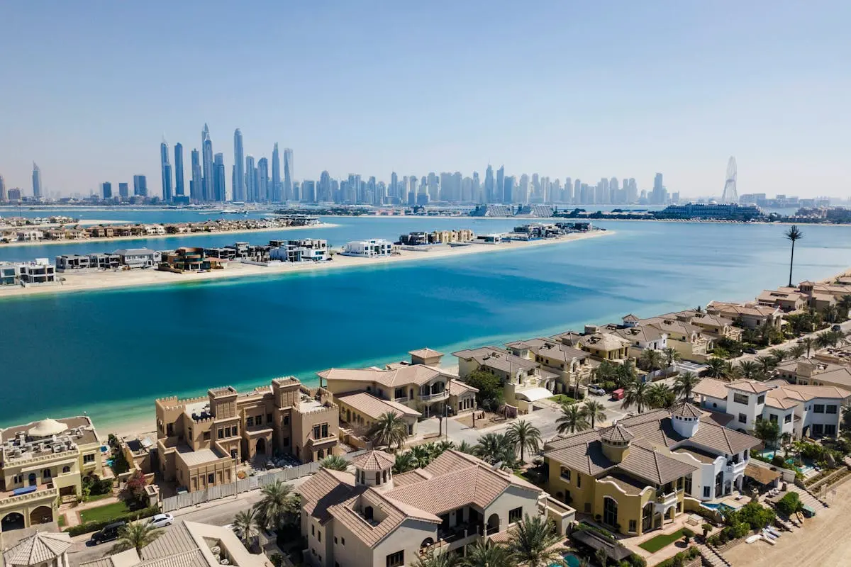 A breathtaking aerial view of Dubai’s skyscrapers and luxury villas on a sunny day.
