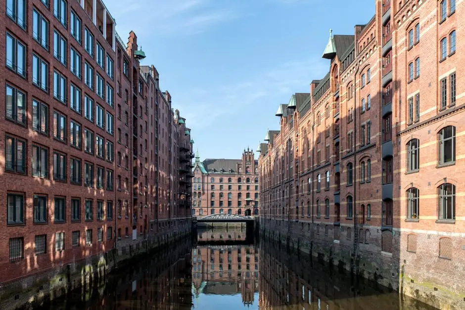 Explore the iconic Speicherstadt with its historic brick warehouses and tranquil canal reflections in Hamburg.