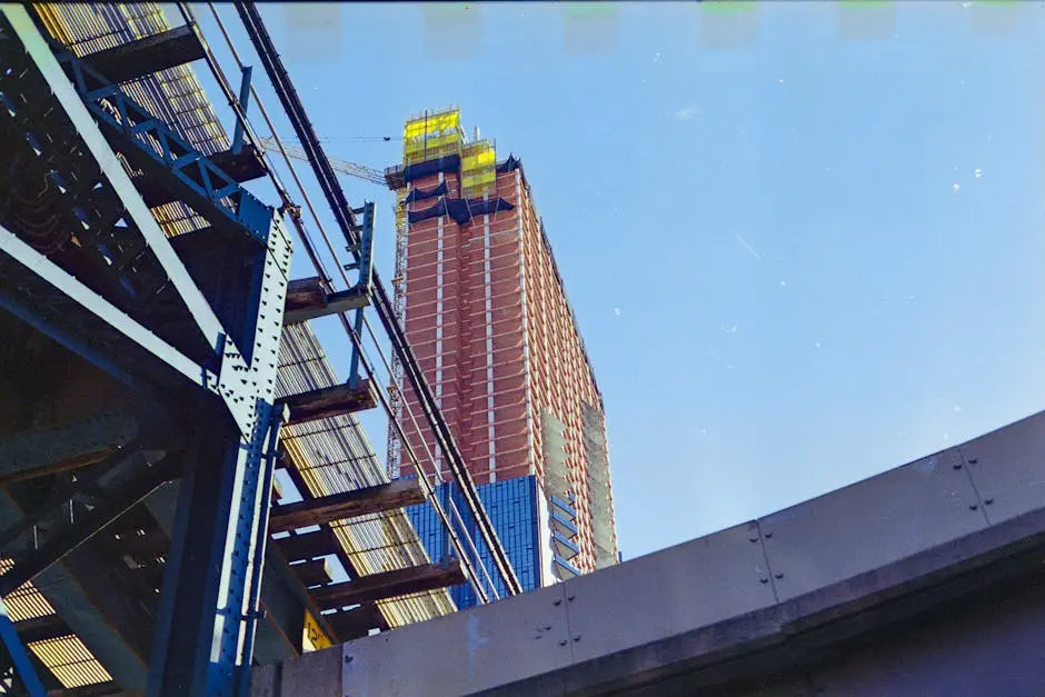 Low angle view of a skyscraper under construction with metal scaffolding in NYC.