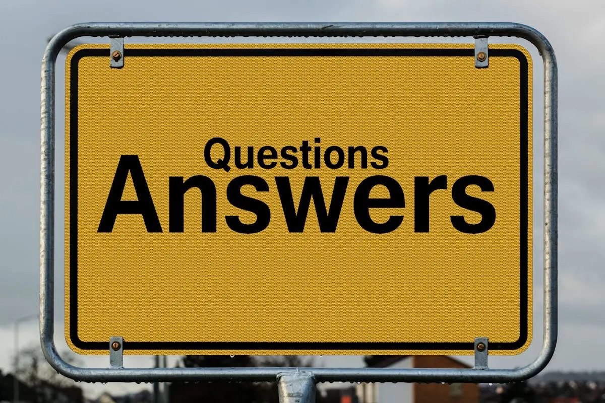 Yellow sign with text questions and answers suggesting direction in decision-making.