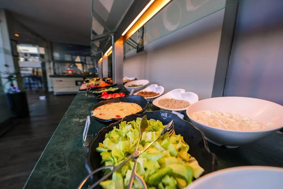 A colorful buffet with various fresh salads and dishes in bowls, perfect for a healthy meal.