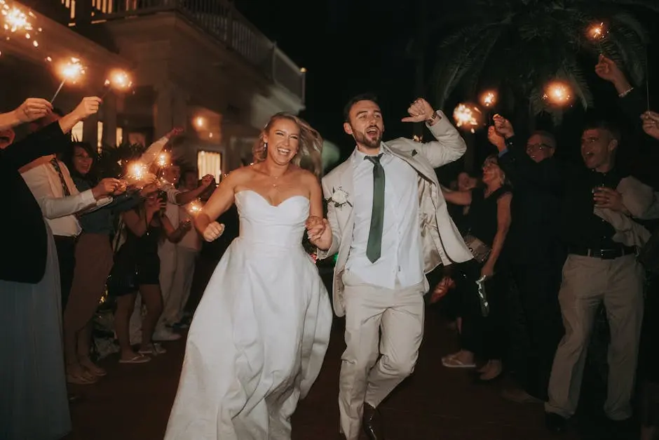 A happy couple runs through sparkler-lit path at their wedding night celebration.