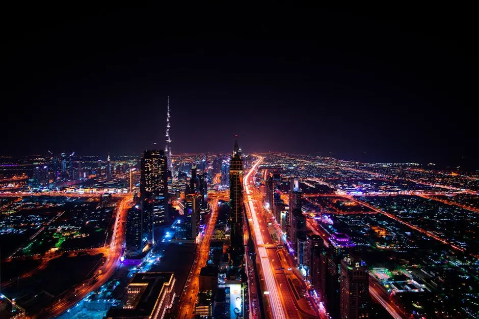A breathtaking aerial view of Dubai&rsquo;s cityscape at night, highlighting the illuminated Burj Khalifa and surrounding skyscrapers.