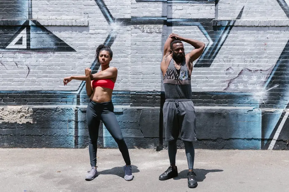 Two people engaging in a dynamic street workout session, showcasing fitness and healthy lifestyle.