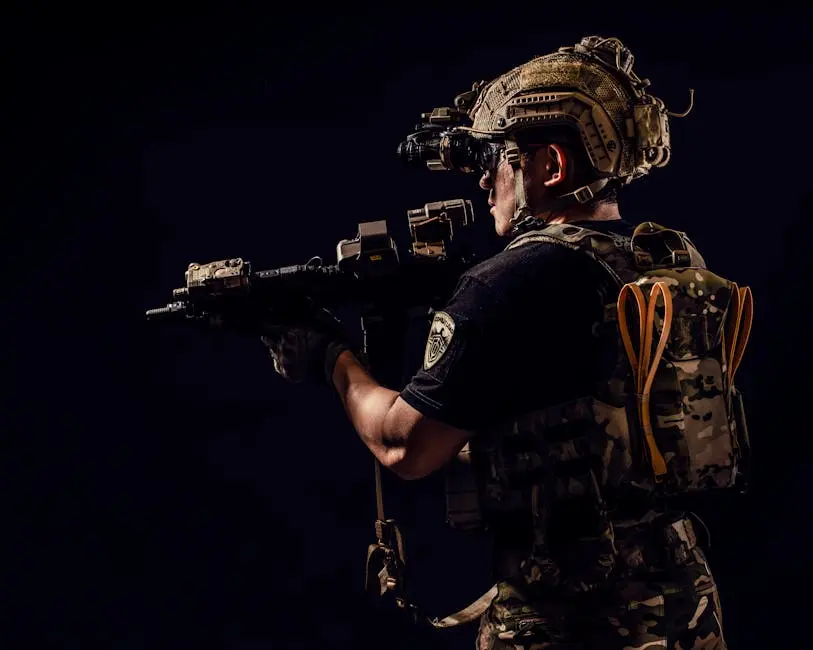 Portrait of a soldier in tactical gear holding a rifle in a studio setting.