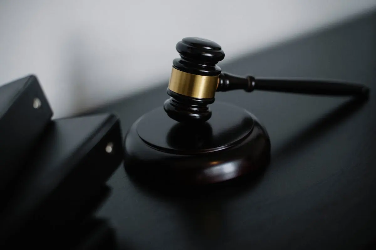 Close-up of a wooden gavel on a desk, symbolizing justice and legal authority and brand enhancement.