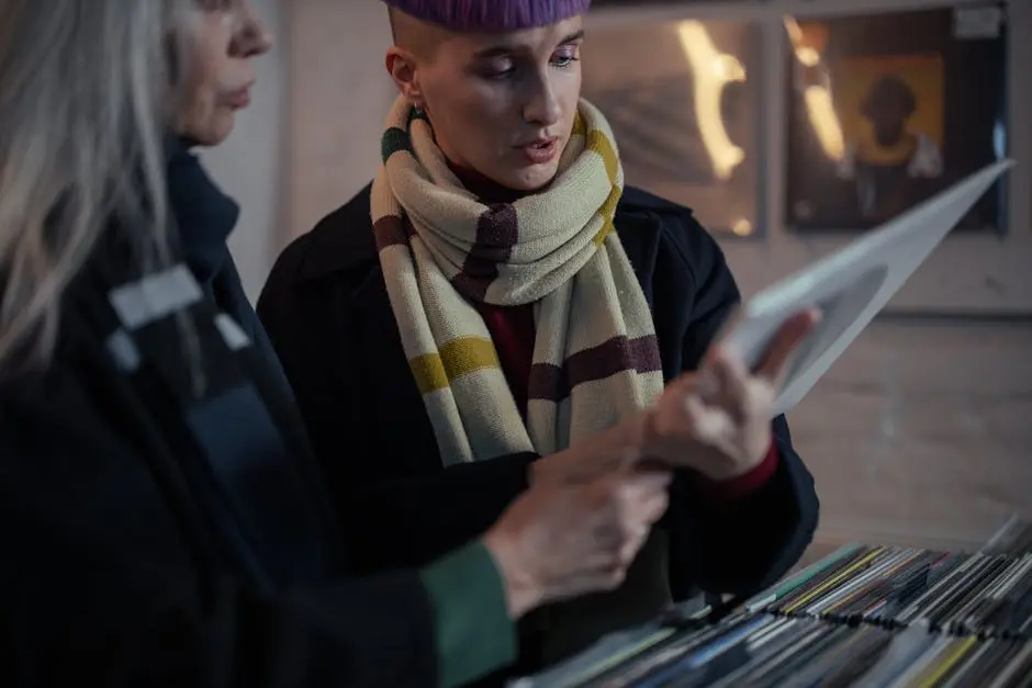 Two young adults exploring vinyl records in an urban record store, wearing stylish winter scarves.