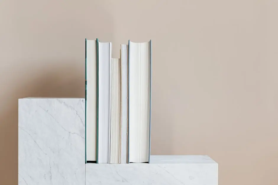 Geometric modern marble shelf with set of various books against beige background