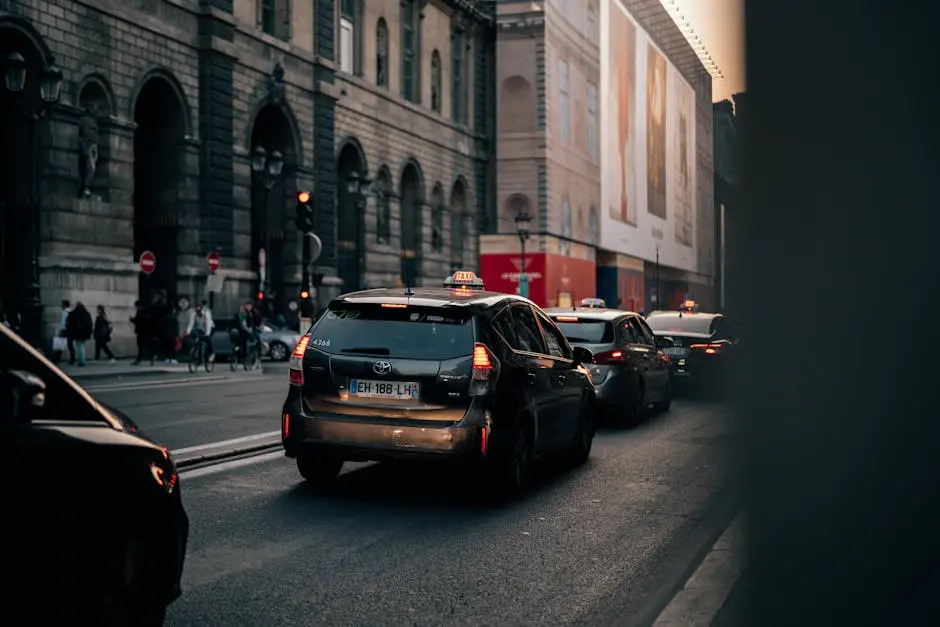 Urban street scene with taxi and cars near Paris Opera Garnier.