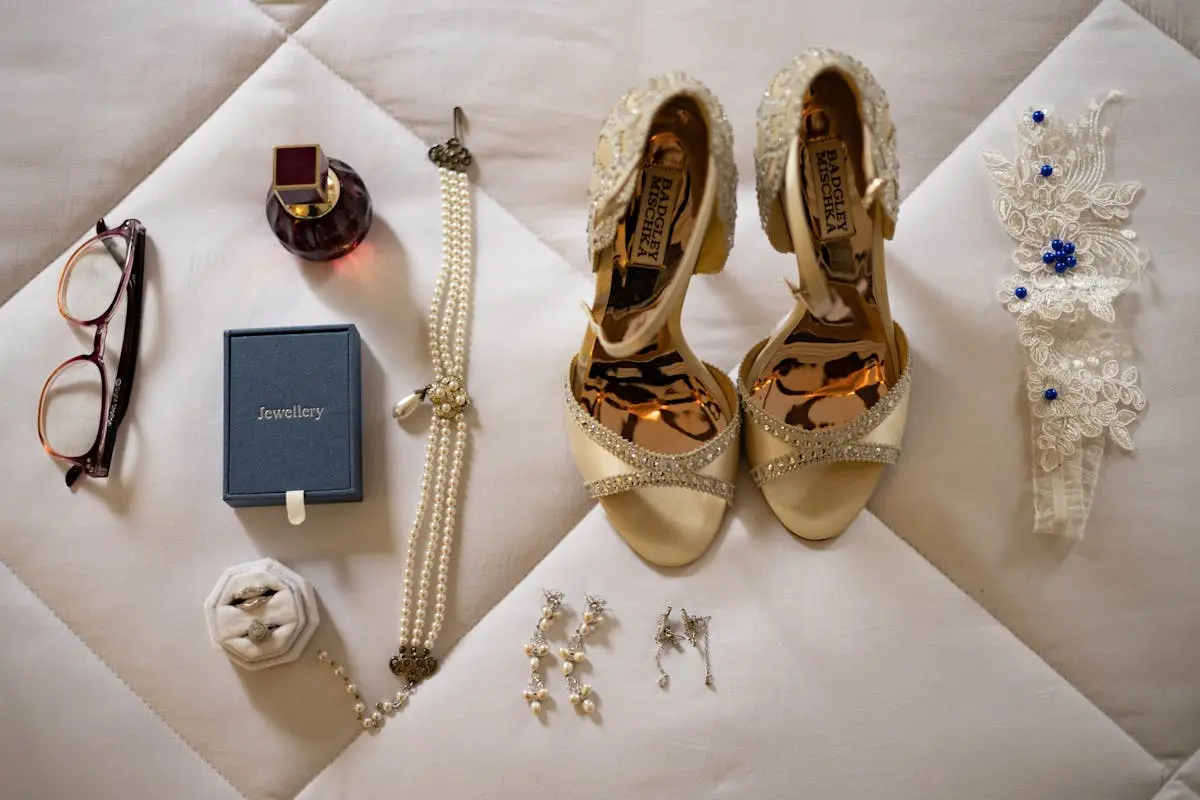A sophisticated flat lay of bridal accessories, including jewelry and high heels.