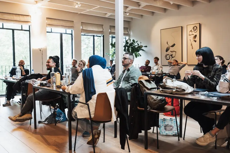 Diverse group of adults engaged in an interactive seminar in a modern, well-lit indoor space.
